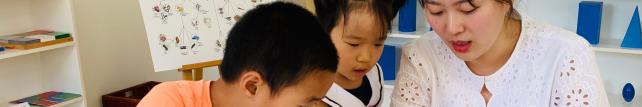 Elementary guide and children discussing document