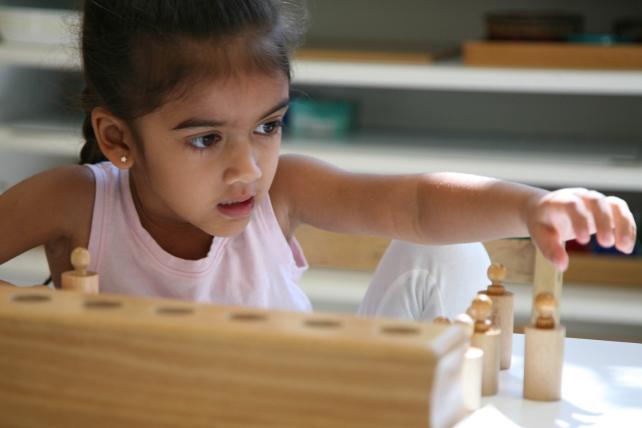 Girl using cylinder blocks