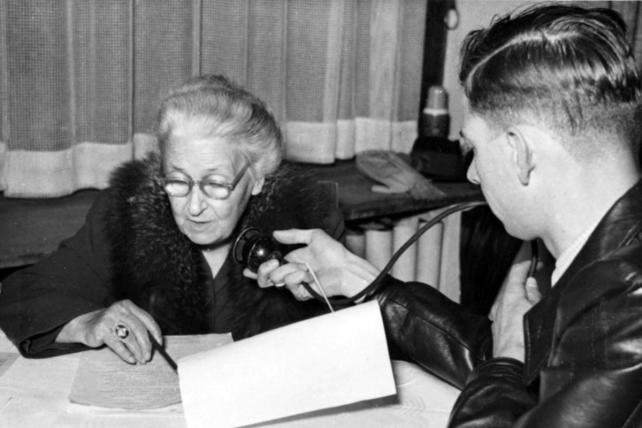 Maria Montessori reviewing a document